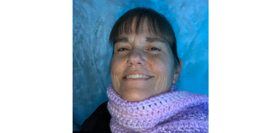 Headshot of Lori, smiling against a blue background