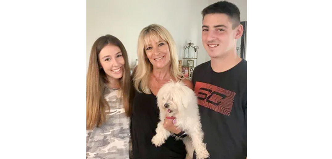 Bari with her son, daughter, and dog, and they are all smiling