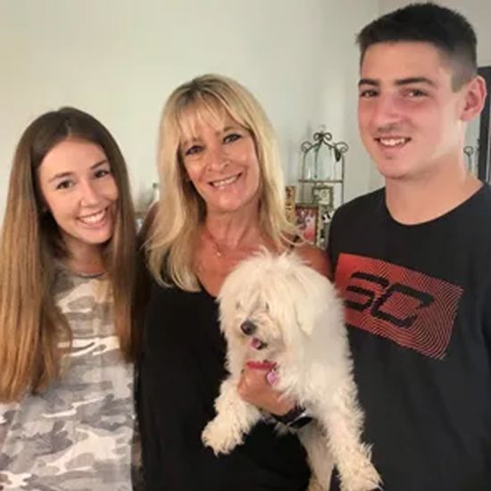 Bari is with her son, daughter, and dog, and they are all smiling.